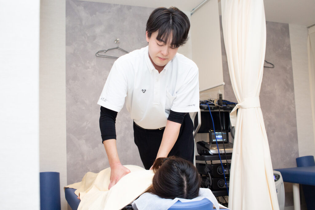 nece.cityの施術スタッフが女性のお客様に整体施術を行っている様子